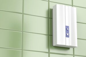 tankless-water-heater-mounted-on-green-tiled-wall