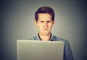 man-frustrated-with-high-heating-bills-on-his-computer