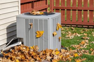 outdoor-unit-of-an-air-conditioner-covered-with-autumn-leaves