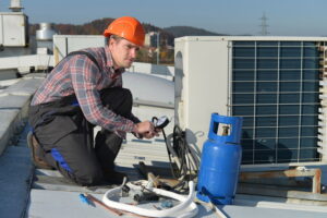 AC-technician-refilling-refrigerant-after-repairing-a-leak