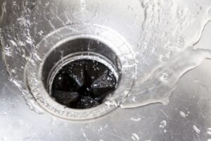 water-swirling-down-a-drain-with-a-garbage-disposal