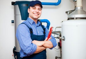 smiling-technician-with-wrench-and-water-heater